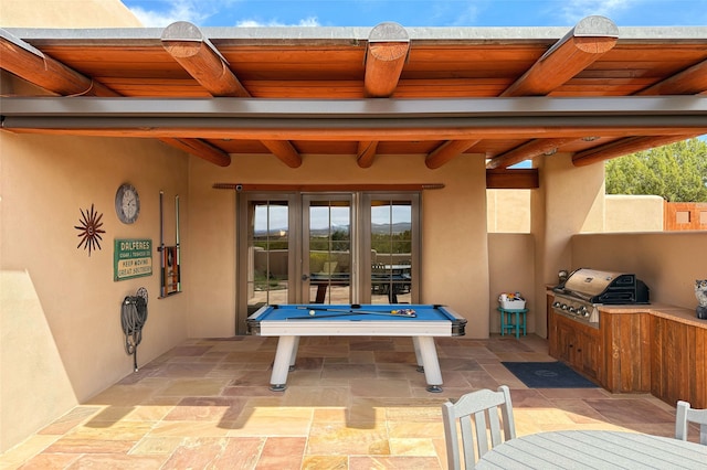 exterior space with french doors, exterior kitchen, and grilling area