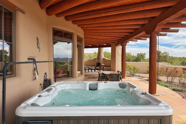 view of patio / terrace with fence and a hot tub