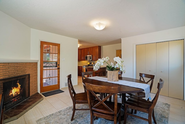 dining area featuring a brick fireplace