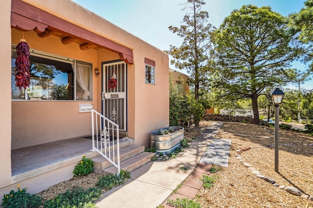entrance to property with stucco siding