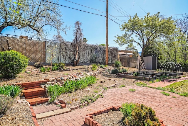 view of yard with a garden and fence