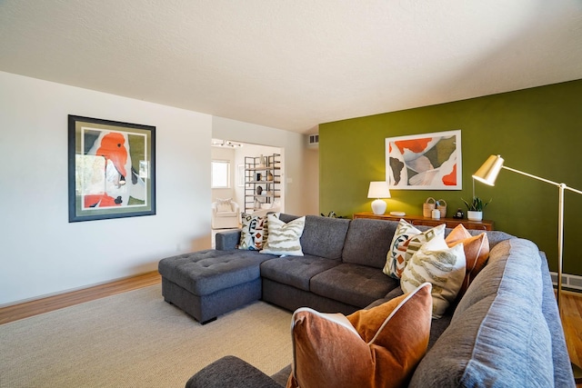living room with visible vents and wood finished floors