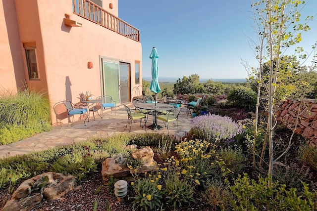 view of patio featuring a balcony