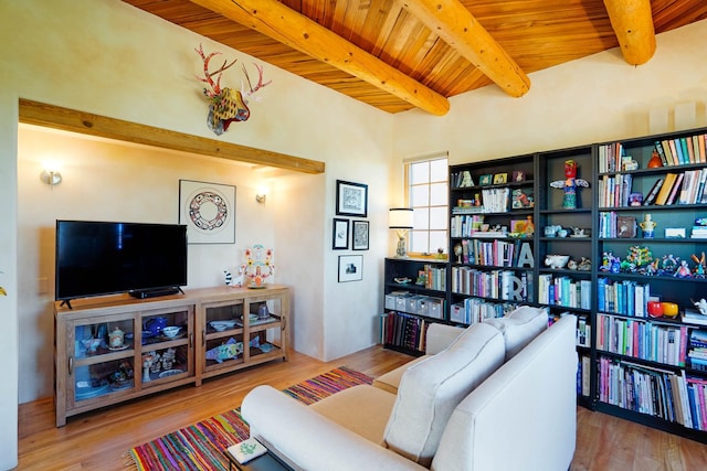 living room featuring beam ceiling, wood ceiling, and wood finished floors