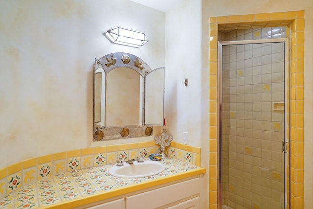 full bath with vanity and a shower stall