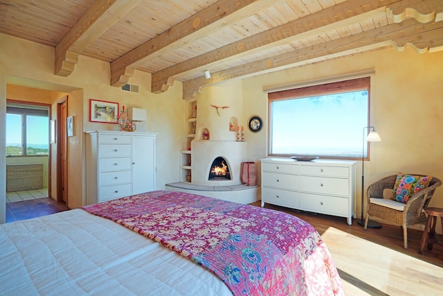 bedroom featuring wooden ceiling, multiple windows, wood finished floors, and visible vents