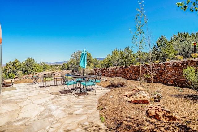 view of patio / terrace with a mountain view and outdoor dining area