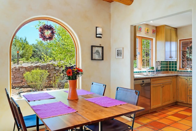dining space featuring light tile patterned floors and plenty of natural light