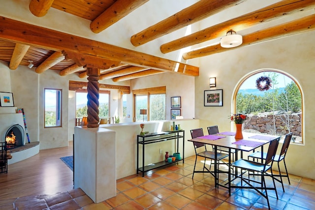 kitchen featuring wooden ceiling, ornate columns, beamed ceiling, and plenty of natural light