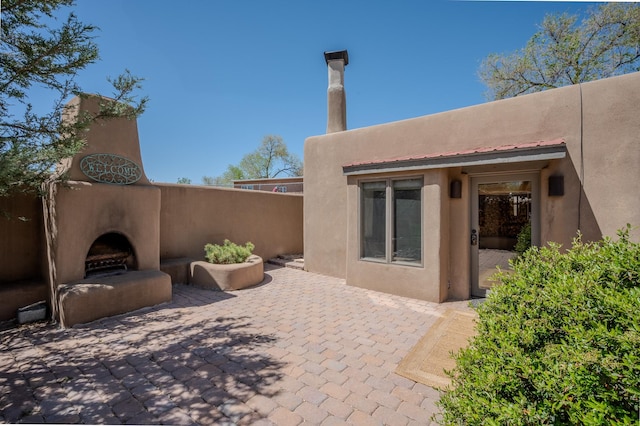 246 Maynard St, Santa Fe, NM 87501 - view of patio with exterior fireplace and fence
