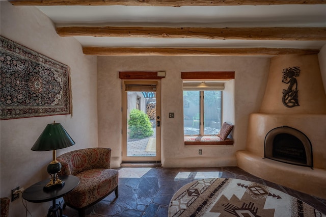 living area with beamed ceiling