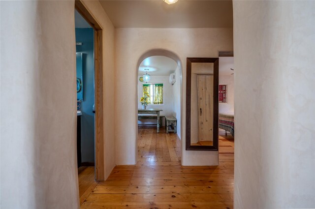 246 Maynard St, Santa Fe, NM 87501 - corridor featuring hardwood / wood-style flooring and arched walkways