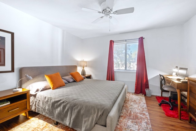 bedroom featuring baseboards, a ceiling fan, and wood finished floors