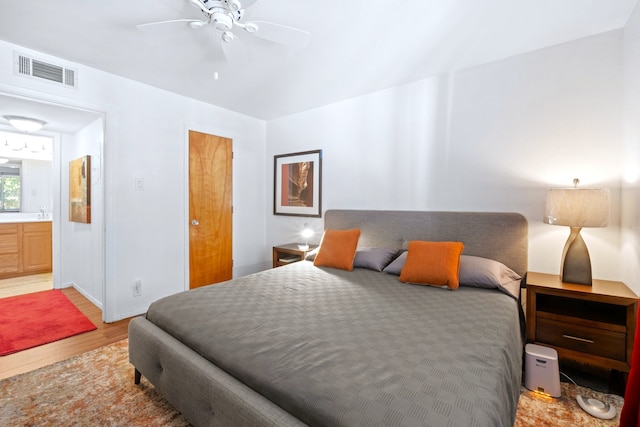 bedroom with baseboards, ceiling fan, light wood finished floors, and visible vents