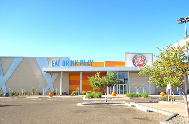 view of building exterior featuring uncovered parking