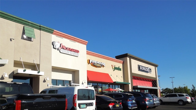 view of building exterior with uncovered parking