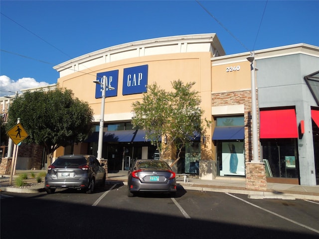 view of building exterior featuring uncovered parking