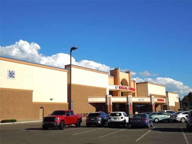 view of building exterior featuring uncovered parking