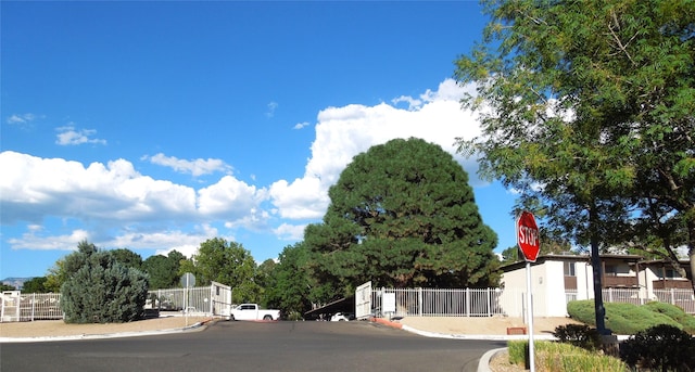 view of road featuring traffic signs and curbs