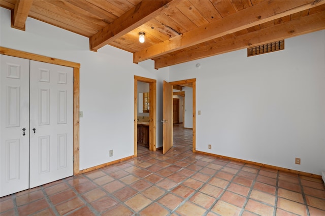 1 Jornada Loop, Santa Fe, NM 87508 - unfurnished bedroom featuring wooden ceiling with exposed beams, baseboards, and a closet