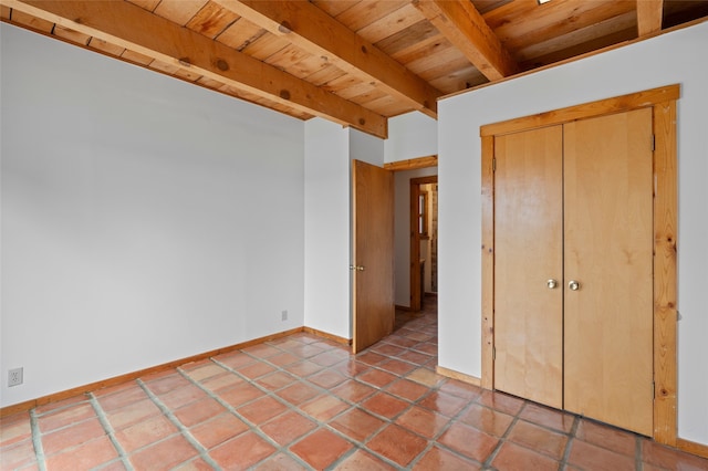 1 Jornada Loop, Santa Fe, NM 87508 - unfurnished bedroom featuring wooden ceiling with exposed beams, baseboards, and a closet