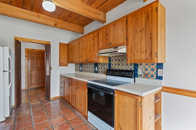 1 Jornada Loop, Santa Fe, NM 87508 - kitchen with black electric range, under cabinet range hood, freestanding refrigerator, decorative backsplash, and light countertops