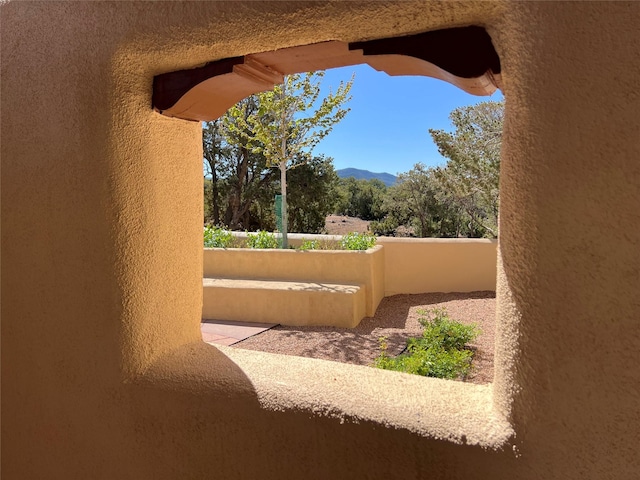 exterior space featuring a mountain view and stucco siding