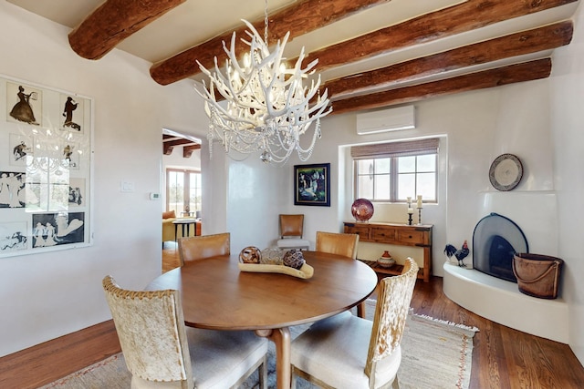 dining space featuring a wall mounted AC, a chandelier, beam ceiling, and wood finished floors