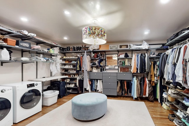 walk in closet with wood finished floors and washing machine and clothes dryer