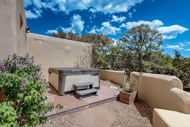 view of patio / terrace with a hot tub