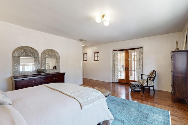 bedroom with visible vents, multiple windows, french doors, and wood finished floors