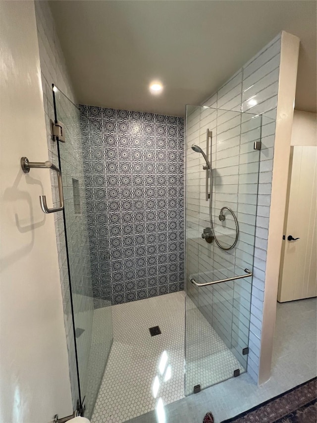 full bathroom with tile patterned floors and a shower stall