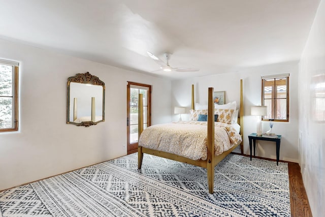 bedroom with multiple windows, ceiling fan, and wood finished floors