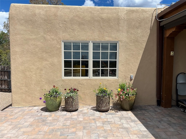 doorway to property with a patio and stucco siding