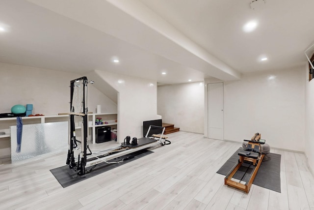 exercise area featuring recessed lighting and wood finished floors