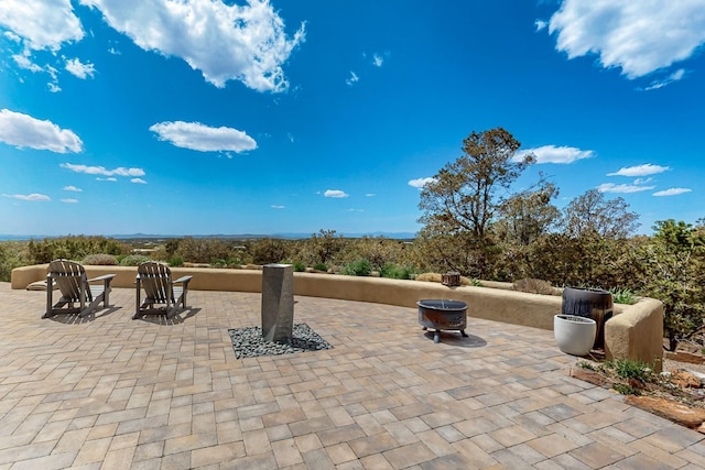 view of patio / terrace with an outdoor fire pit