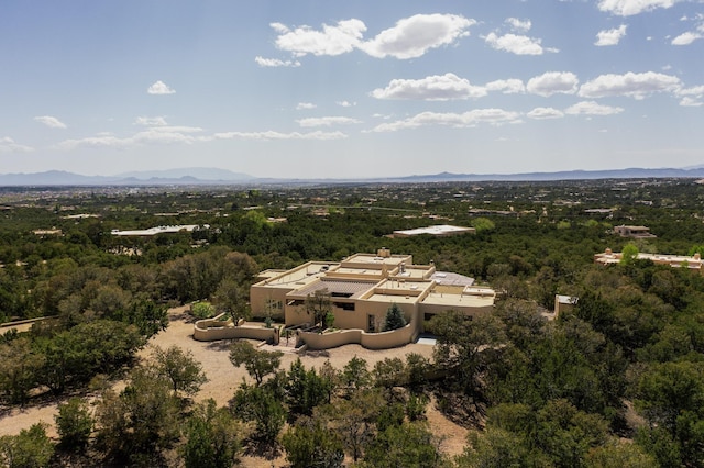 birds eye view of property with a wooded view and a mountain view