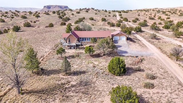 drone / aerial view featuring a desert view and a rural view