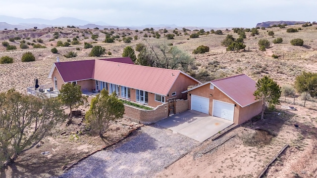 birds eye view of property featuring a mountain view and view of desert