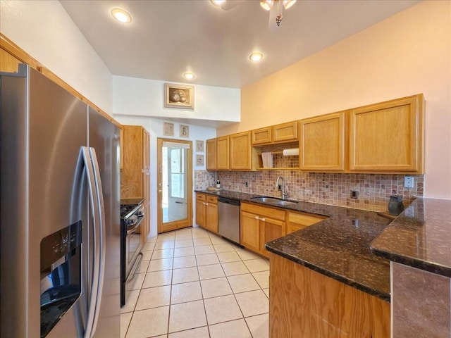 4621 Esperanza, Los Alamos, NM 87544 - kitchen featuring a peninsula, light tile patterned flooring, a sink, appliances with stainless steel finishes, and backsplash