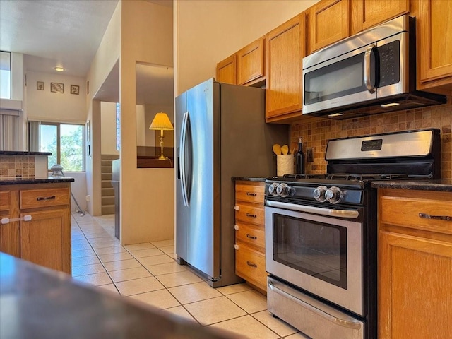 4621 Esperanza, Los Alamos, NM 87544 - kitchen featuring light tile patterned floors, decorative backsplash, stainless steel appliances, and brown cabinets