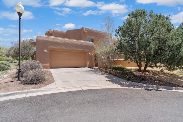3101 Old Pecos Trl Unit 627, Santa Fe, NM 87505 - pueblo-style house with concrete driveway and a garage