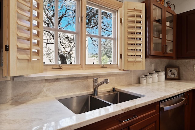 3101 Old Pecos Trl Unit 627, Santa Fe, NM 87505 - kitchen featuring a sink, tasteful backsplash, dishwasher, glass insert cabinets, and light stone countertops