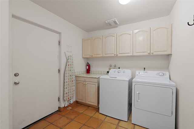 3101 Old Pecos Trl Unit 627, Santa Fe, NM 87505 - washroom with washing machine and dryer, cabinet space, light tile patterned floors, and visible vents