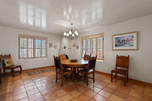 3101 Old Pecos Trl Unit 627, Santa Fe, NM 87505 - dining area featuring baseboards, a notable chandelier, a healthy amount of sunlight, and light tile patterned flooring