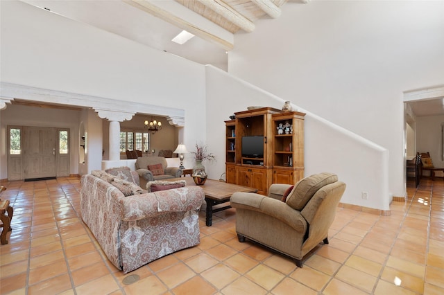 3101 Old Pecos Trl Unit 627, Santa Fe, NM 87505 - living room with an inviting chandelier, a towering ceiling, light tile patterned floors, and beam ceiling
