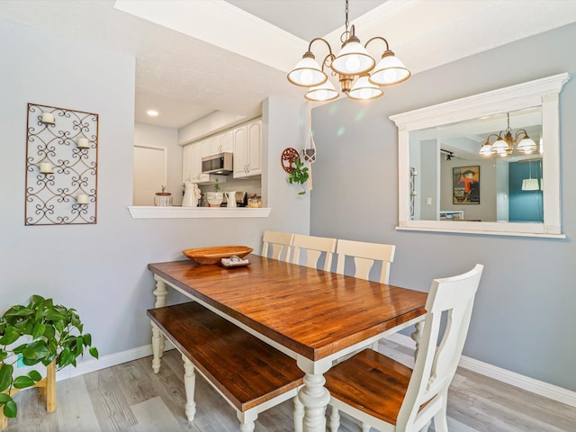 505 Oppenheimer Dr Unit 1304, Los Alamos, NM 87544 - dining space with baseboards, light wood-type flooring, and a notable chandelier