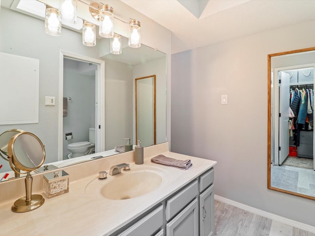 505 Oppenheimer Dr Unit 1304, Los Alamos, NM 87544 - full bathroom featuring vanity, toilet, wood finished floors, and a walk in closet