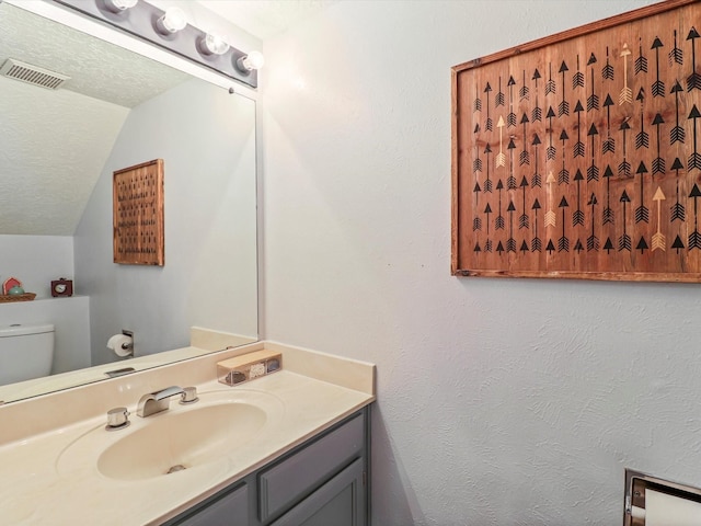 505 Oppenheimer Dr Unit 1304, Los Alamos, NM 87544 - bathroom featuring visible vents, lofted ceiling, toilet, and vanity