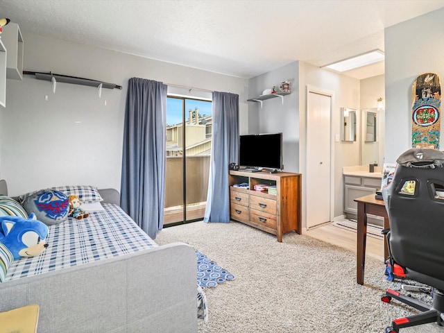 505 Oppenheimer Dr Unit 1304, Los Alamos, NM 87544 - bedroom featuring access to outside, light carpet, and ensuite bathroom